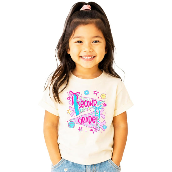 Girls 2nd grade floral pennant graphic tee with coquette bows and pink lettering on natural cotton shirt
