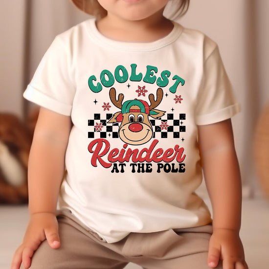 Boys holiday graphic tee laid flat showing Coolest Reindeer at the Pole design, natural color