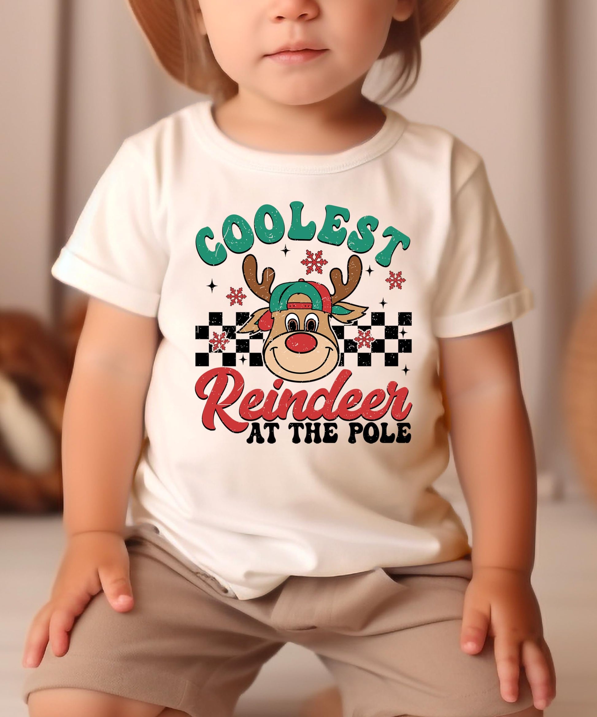 Boys holiday graphic tee laid flat showing Coolest Reindeer at the Pole design, natural color
