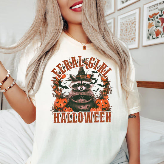 Close-up of witchy raccoon Halloween graphic print on seafoam green women's tee