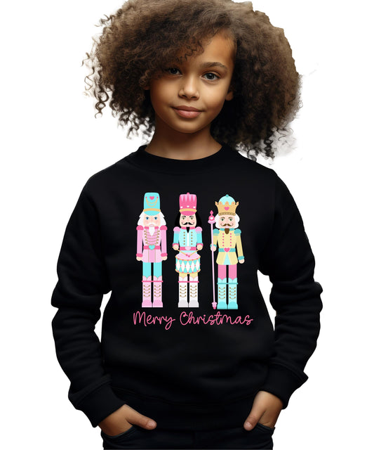 Close-up of pastel nutcracker graphic with Merry Christmas text on holiday sweatshirt