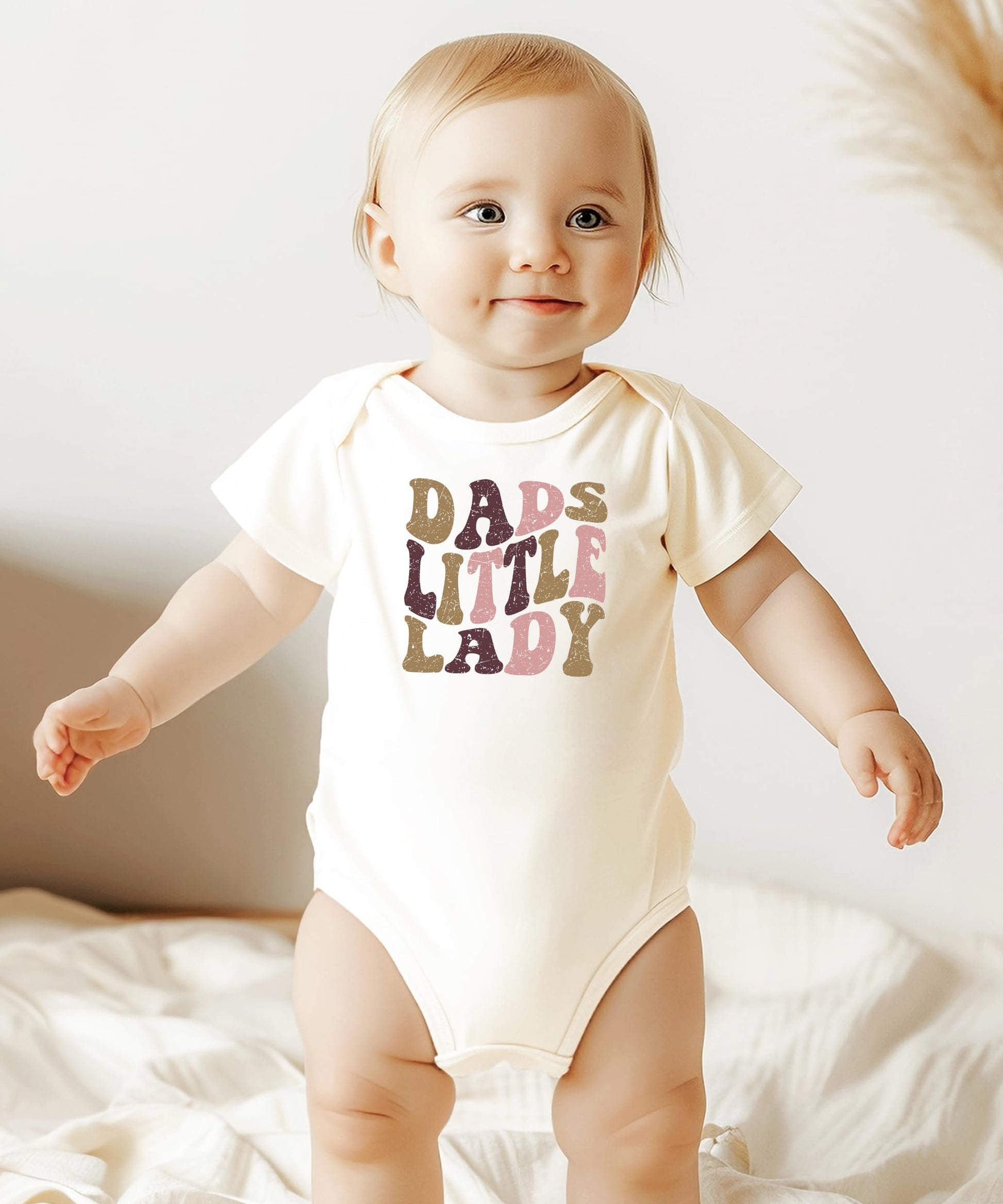Back view of Dad's Little Lady baby girl one-piece snap bodysuit in peach