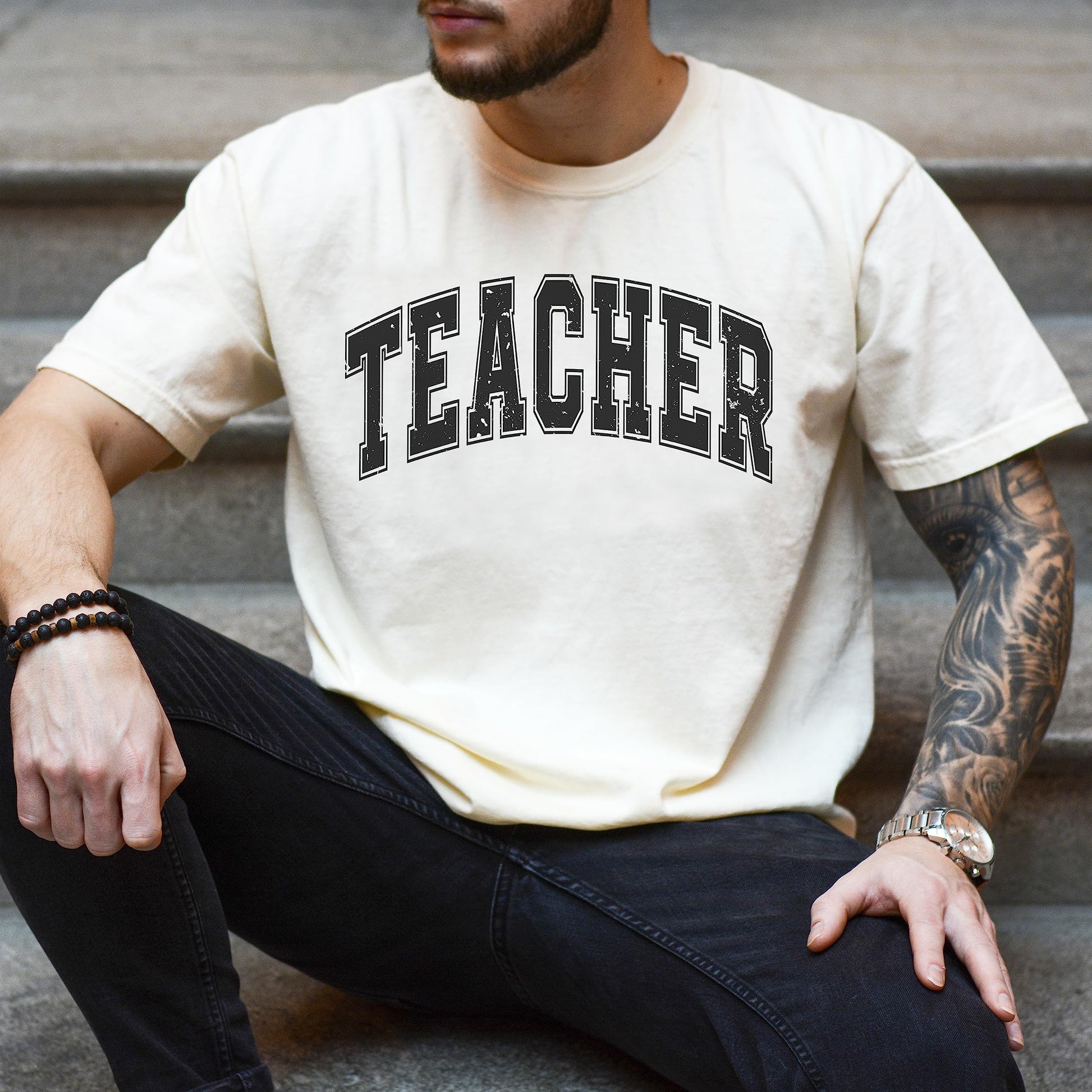 Gray teacher varsity t-shirt laid flat showing unisex fit and sizing