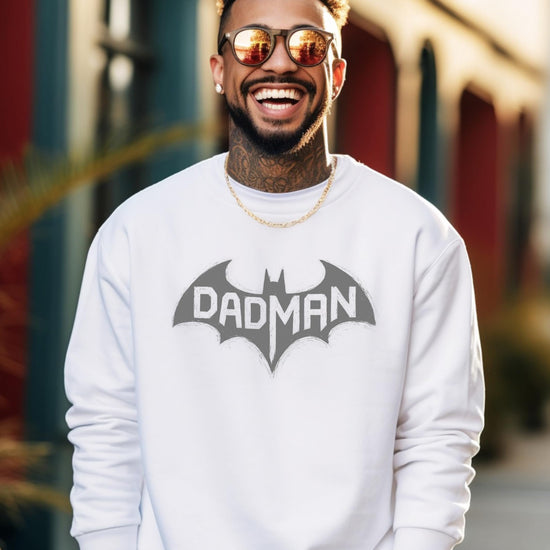 Close-up of DadMan bat superhero graphic print on men's white pullover sweatshirt