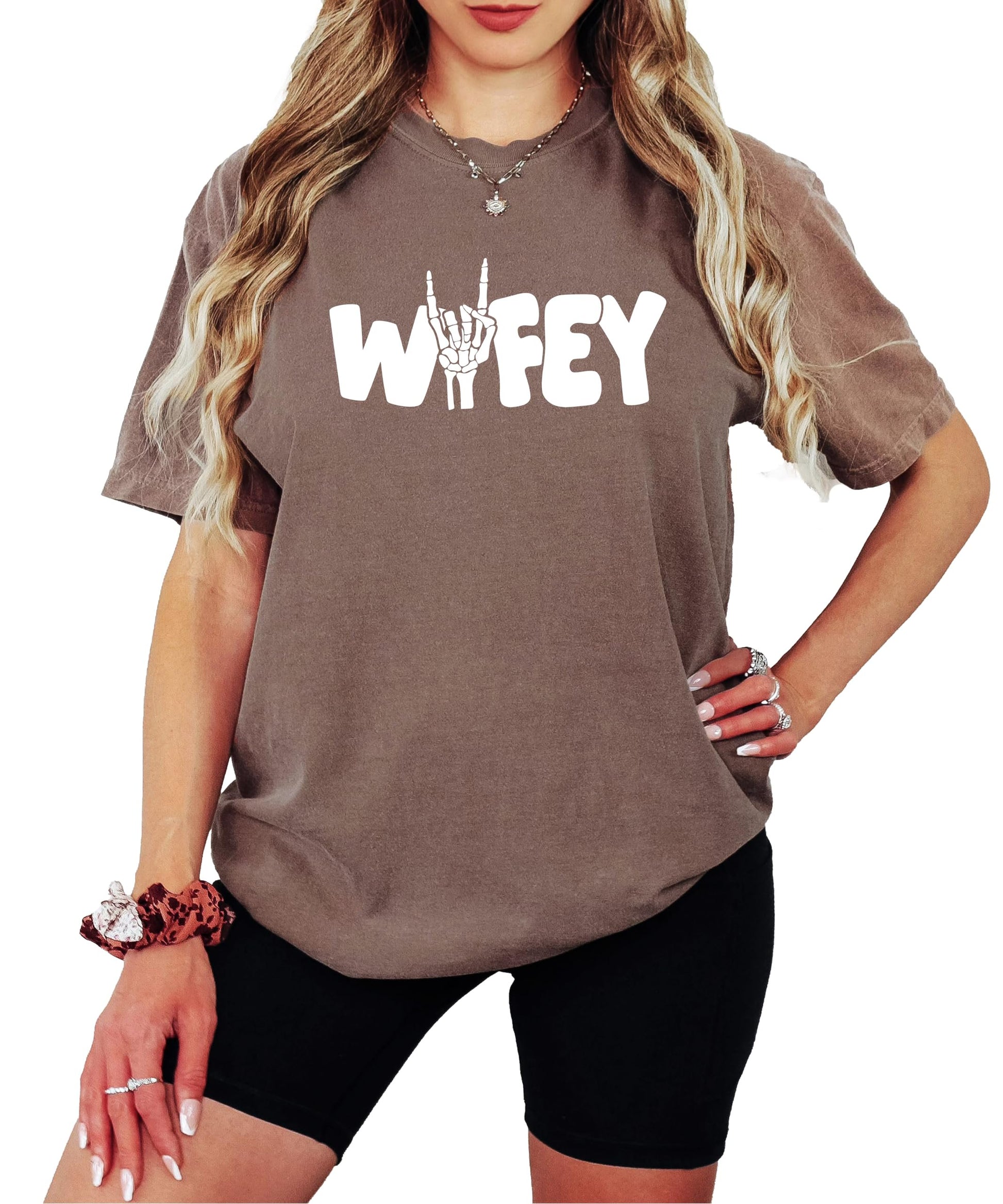 Woman wearing trendy Wifey skeleton Halloween shirt showing fit and style