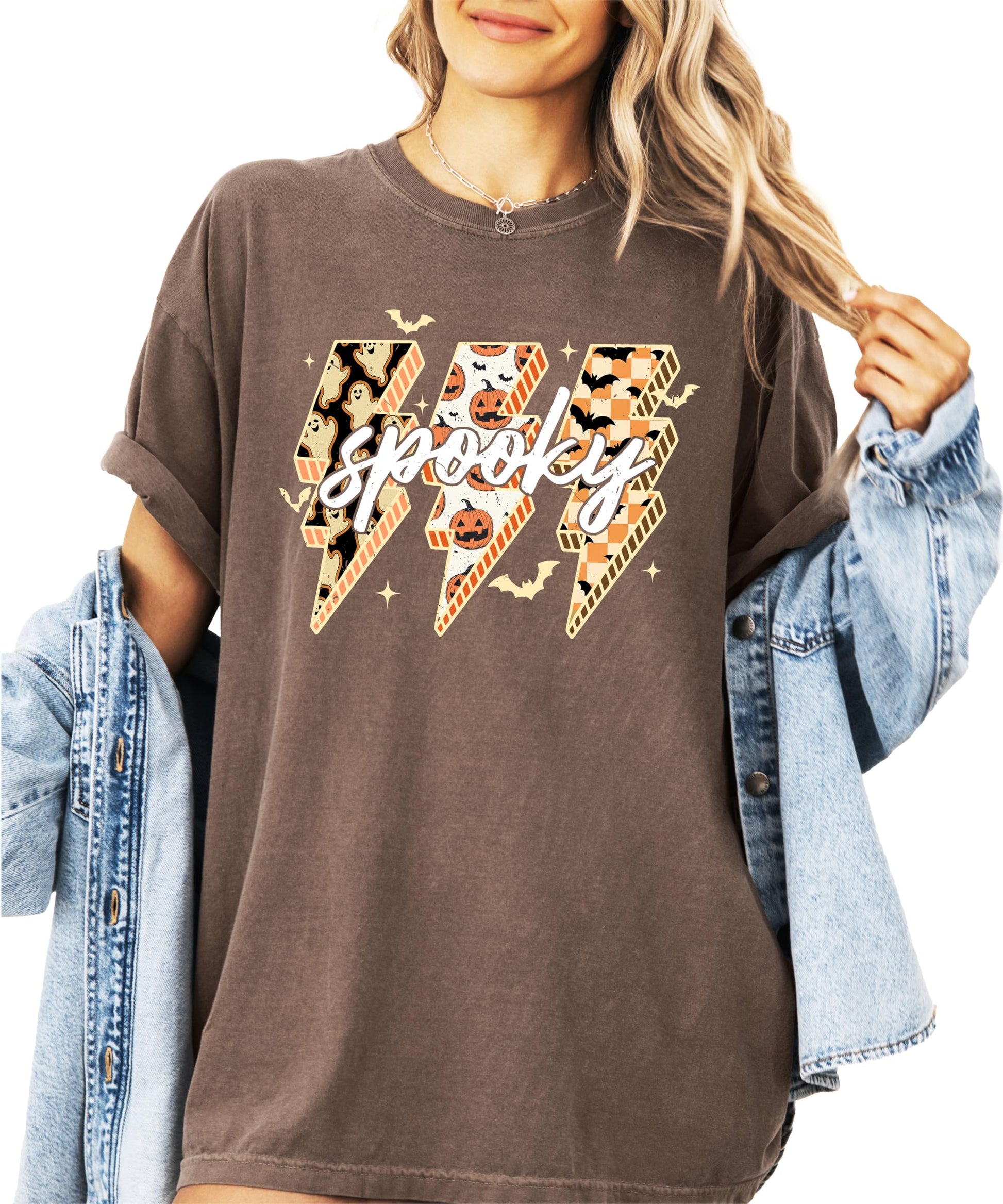 Women's espresso brown oversized graphic tee with spooky lightning bolt design featuring ghosts, pumpkins, and bats