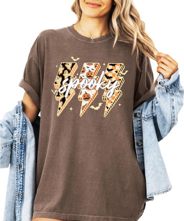 Women's espresso brown oversized graphic tee with spooky lightning bolt design featuring ghosts, pumpkins, and bats