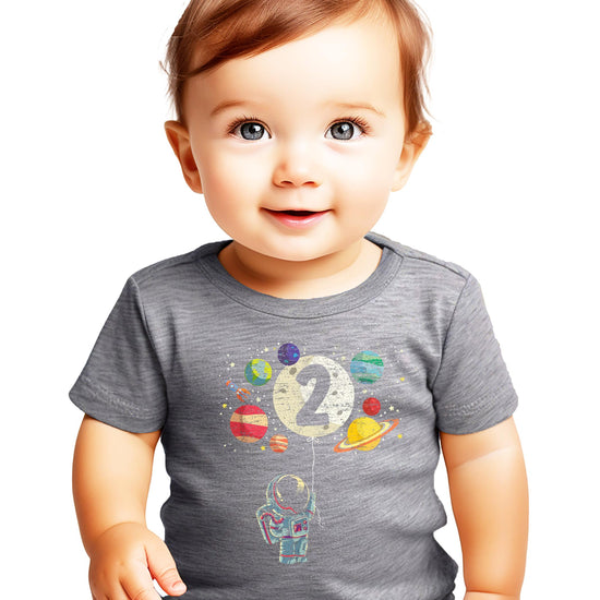 Close-up of vibrant astronaut and rocket graphic on black toddler birthday t-shirt