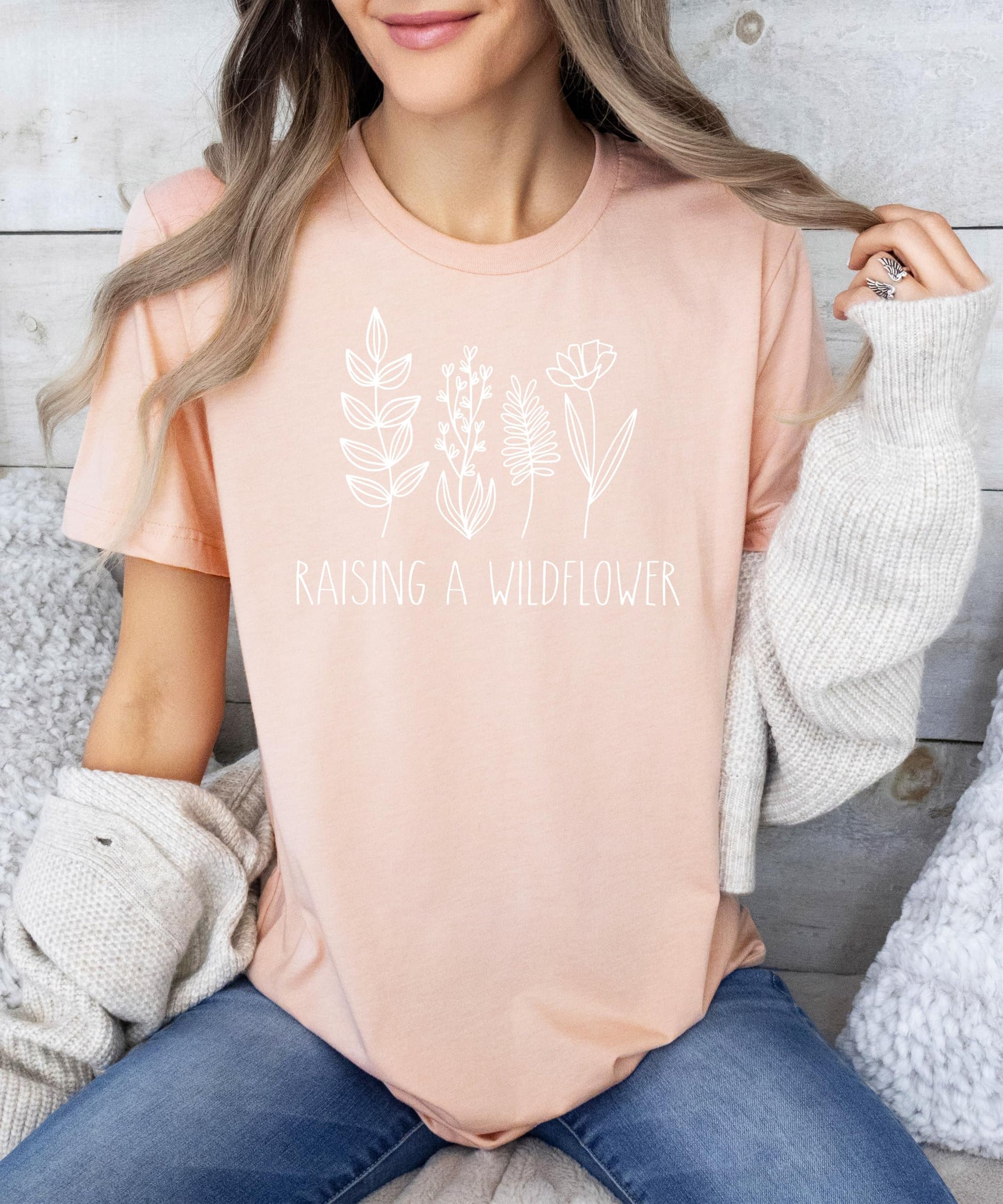 Flat lay of mommy and me wildflower matching shirts in mauve and white