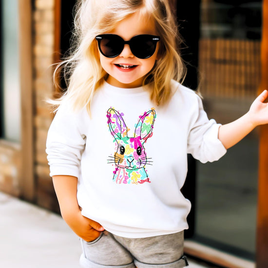 Flat lay of kids white Easter Bunny sweatshirt with colorful bow graphic detail