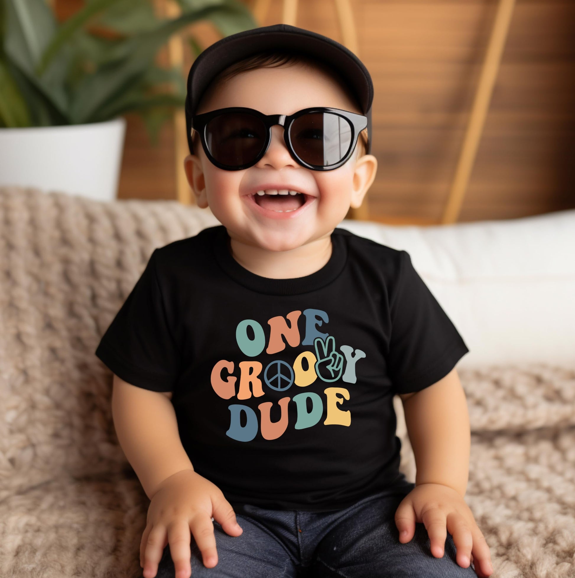 Flat lay of baby boy groovy one birthday shirt showing full graphic print and natural fabric