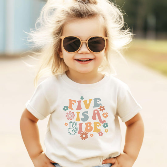Kids' fifth birthday graphic tee in natural color with groovy flower power lettering design