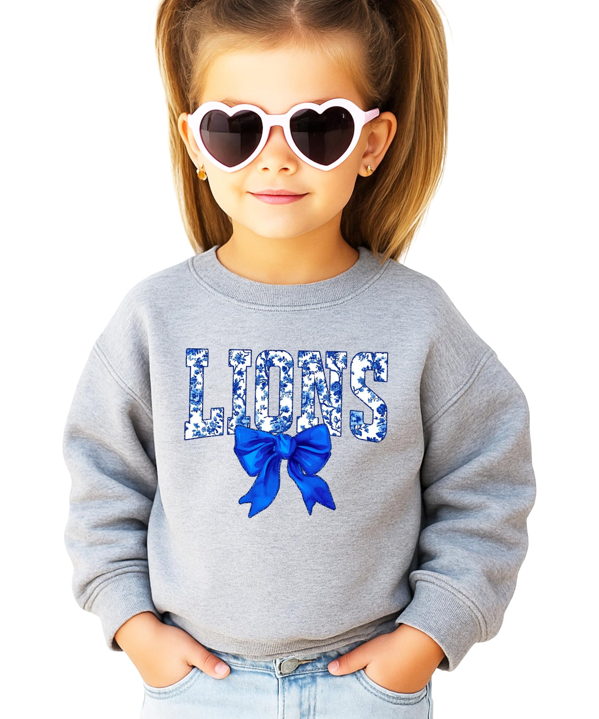 Close-up of bold blue floral LIONS print and decorative bow on black sweatshirt