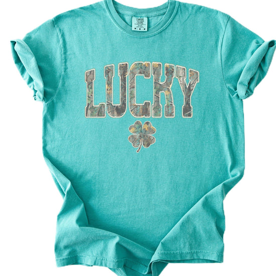 Close-up of camo block letter lucky print with shamrock clover on St. Patrick's Day graphic tee