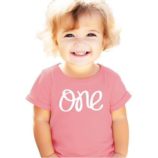 Toddler girl wearing a purple first birthday shirt perfect for a birthday party outfit