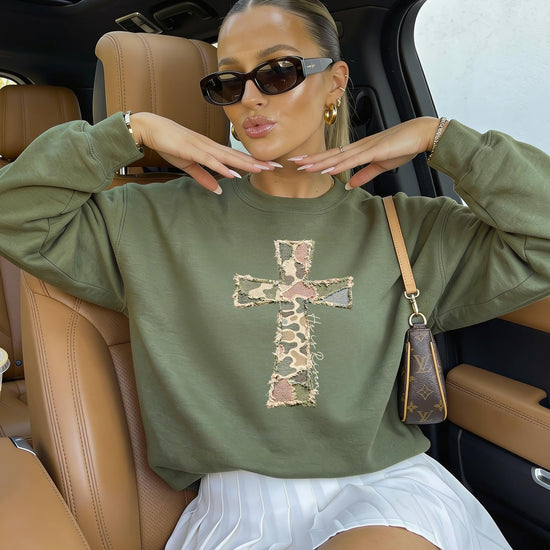 Back or side view of women's camo Christian cross sweatshirt He Is Risen Easter pullover