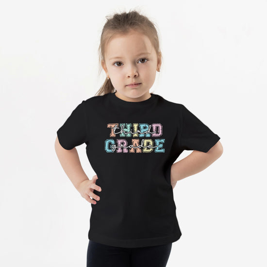 Third grade girls shirt flat lay showing full design and fit