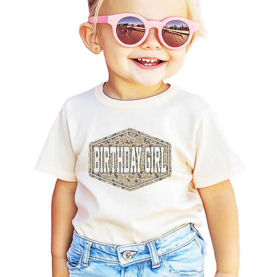 Model wearing camo birthday girl shirt, styled for birthday celebration