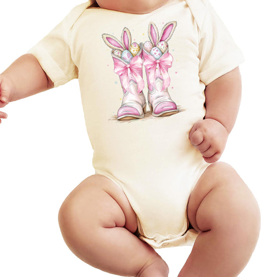 Close-up of Easter cowboy boots and pastel eggs graphic on soft baby girl bodysuit