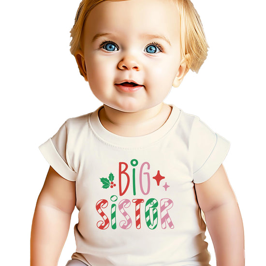 Close-up of candy cane stripe and holly graphic print on girls big sister holiday tee