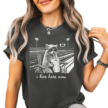 Lifestyle shot of I Live Here Now football mom graphic tee styled for tailgate or spirit night