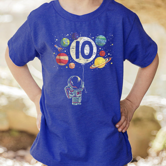 Close-up of astronaut holding number 10 balloon with planets on boys birthday tee