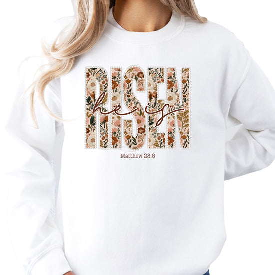 Lifestyle photo of woman wearing He Is Risen floral Christian sweatshirt in army green