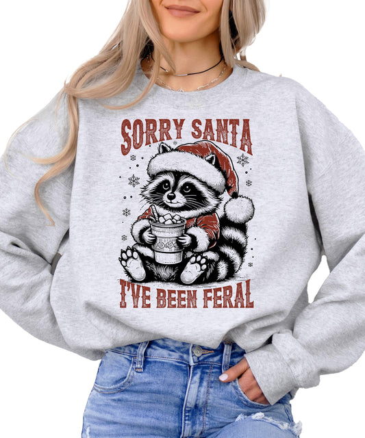 Natural heather sweatshirt laying flat showing complete feral raccoon holiday design