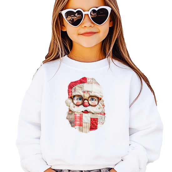 Close-up of faux patch Santa design on black sweatshirt showing vintage-style glasses and festive holiday print