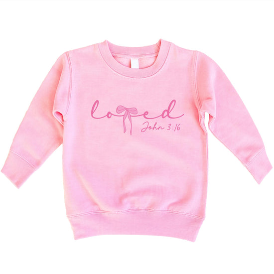 Close-up of John 3:16 pink bow graphic print on cozy white Valentine's sweatshirt