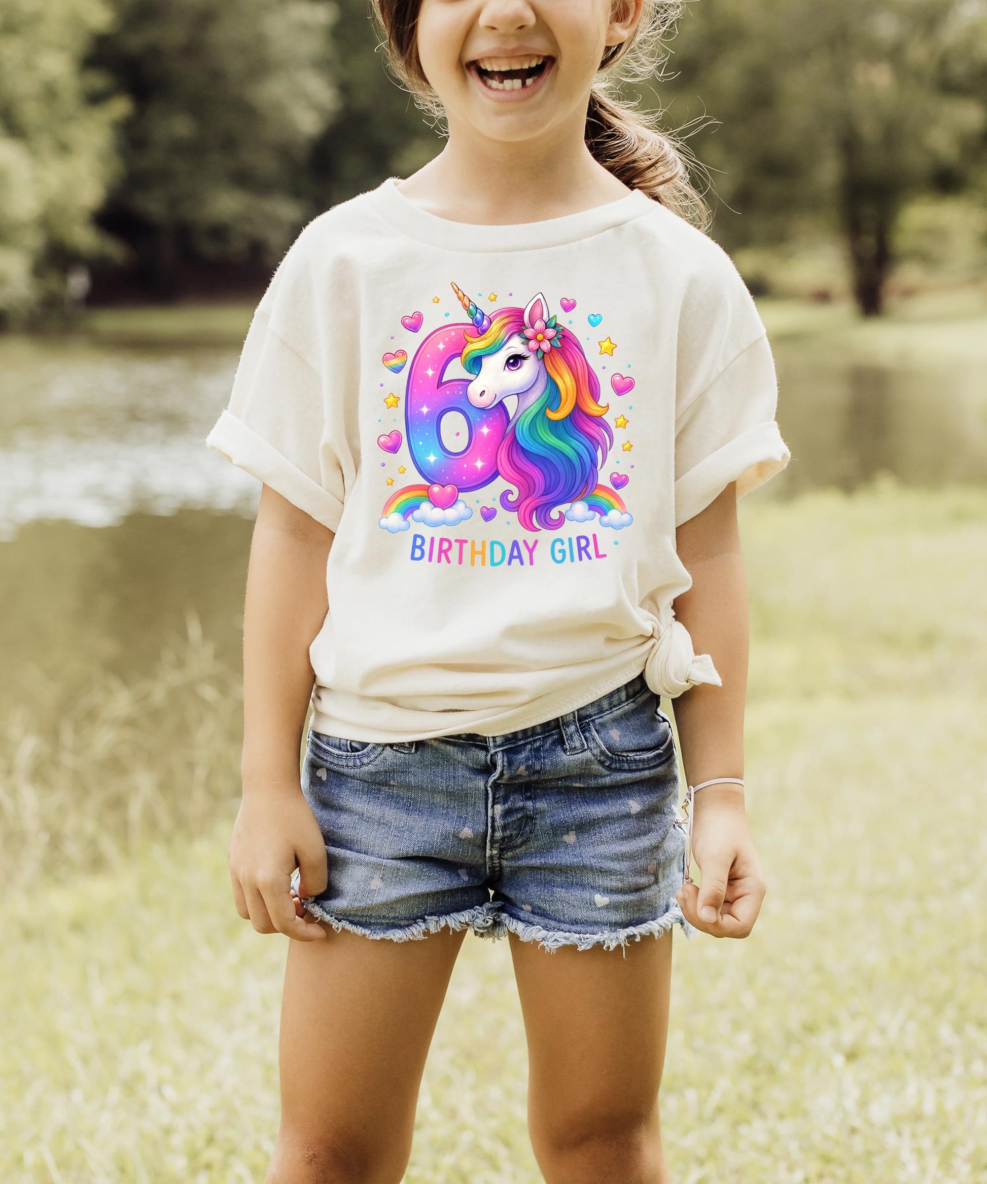Girls wearing 6th birthday unicorn shirt in pink with rainbow horse party theme graphic