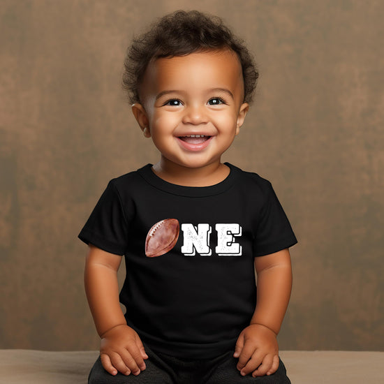 Detail shot of distressed football outline graphic on boys 1st birthday tee