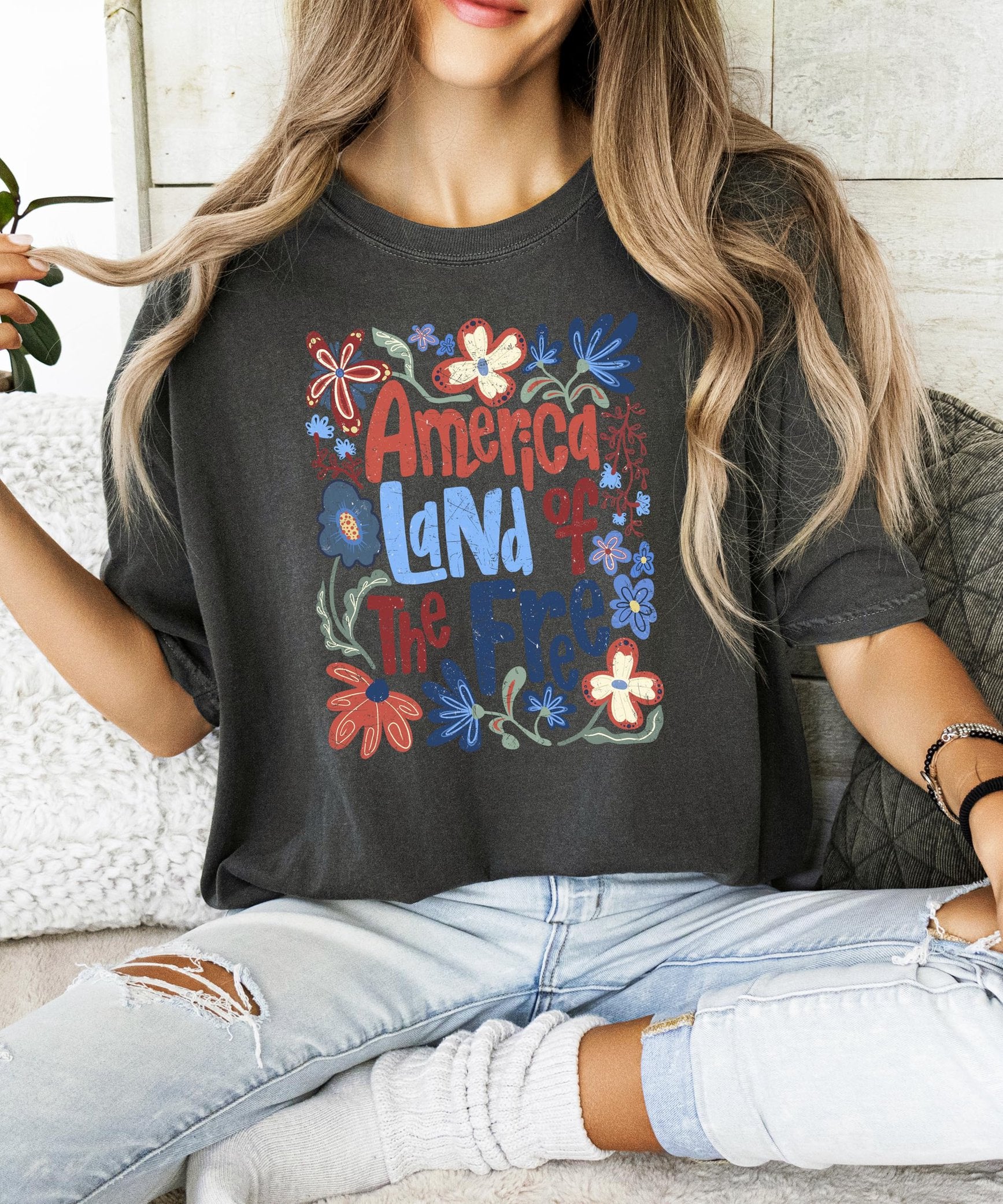 Detail shot of red white and blue floral design on patriotic women's graphic tee