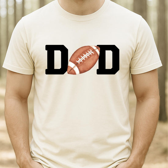 Flat lay of natural football Mom birthday tee showing full graphic design