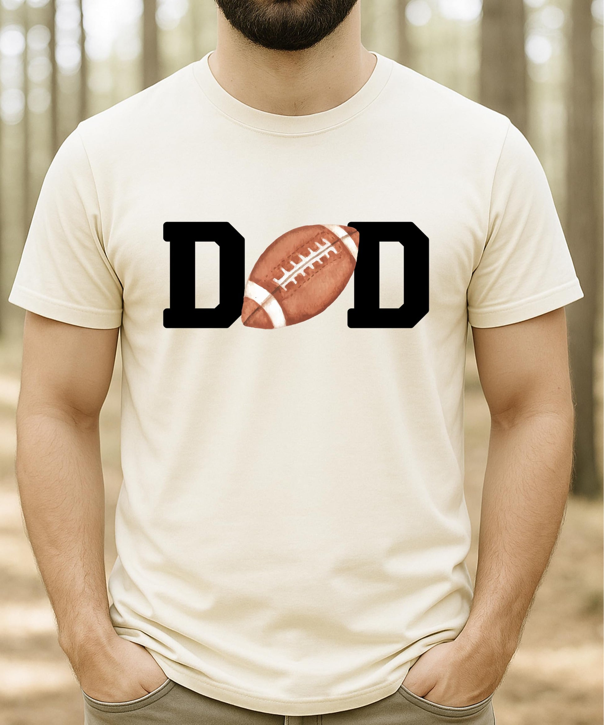 Flat lay of natural football Mom birthday tee showing full graphic design