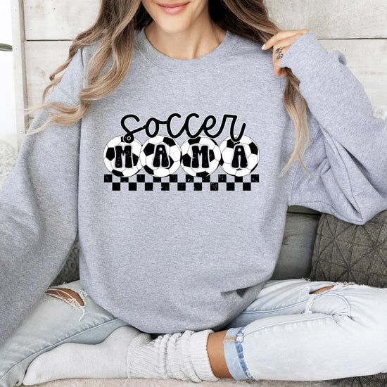 Women's casual red Soccer Mama sweatshirt laid flat, full view of graphic design