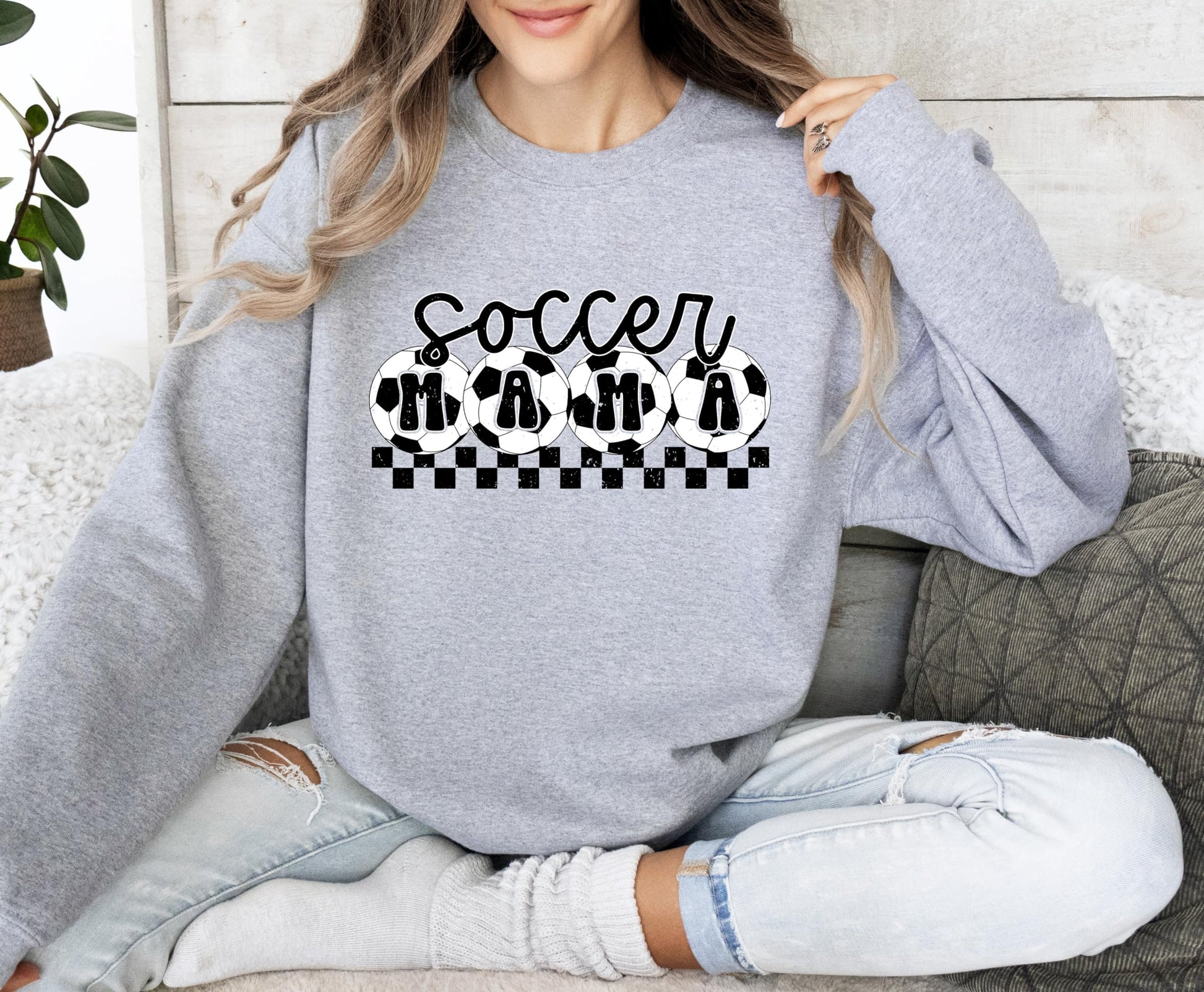 Women's casual red Soccer Mama sweatshirt laid flat, full view of graphic design