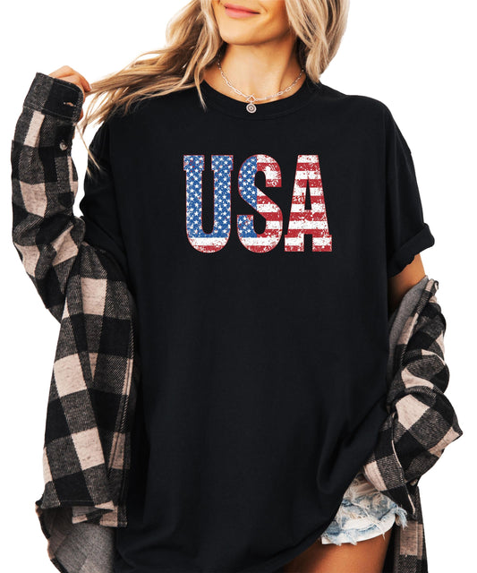Distressed USA flag graphic tee in black with bold vintage-style lettering for 4th of July