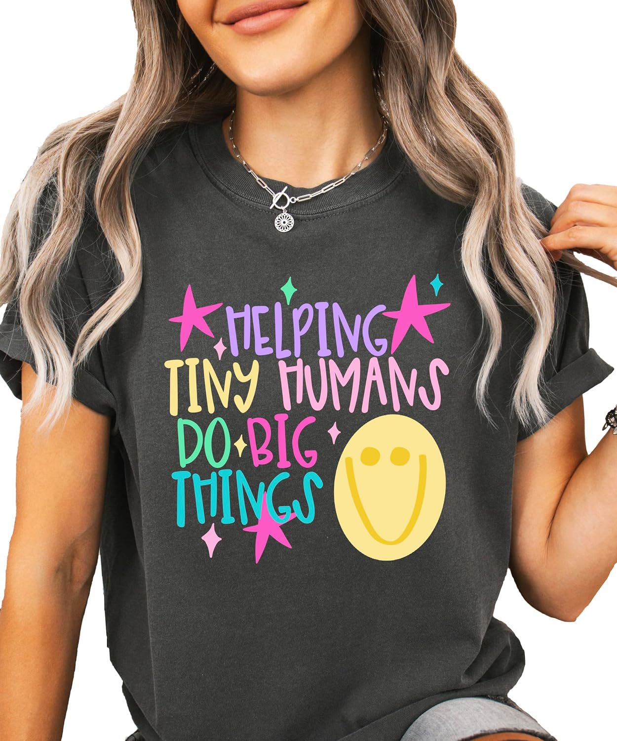 Back or side view of Helping Tiny Humans Do Big Things preschool teacher graphic tee by Olive Loves Apple