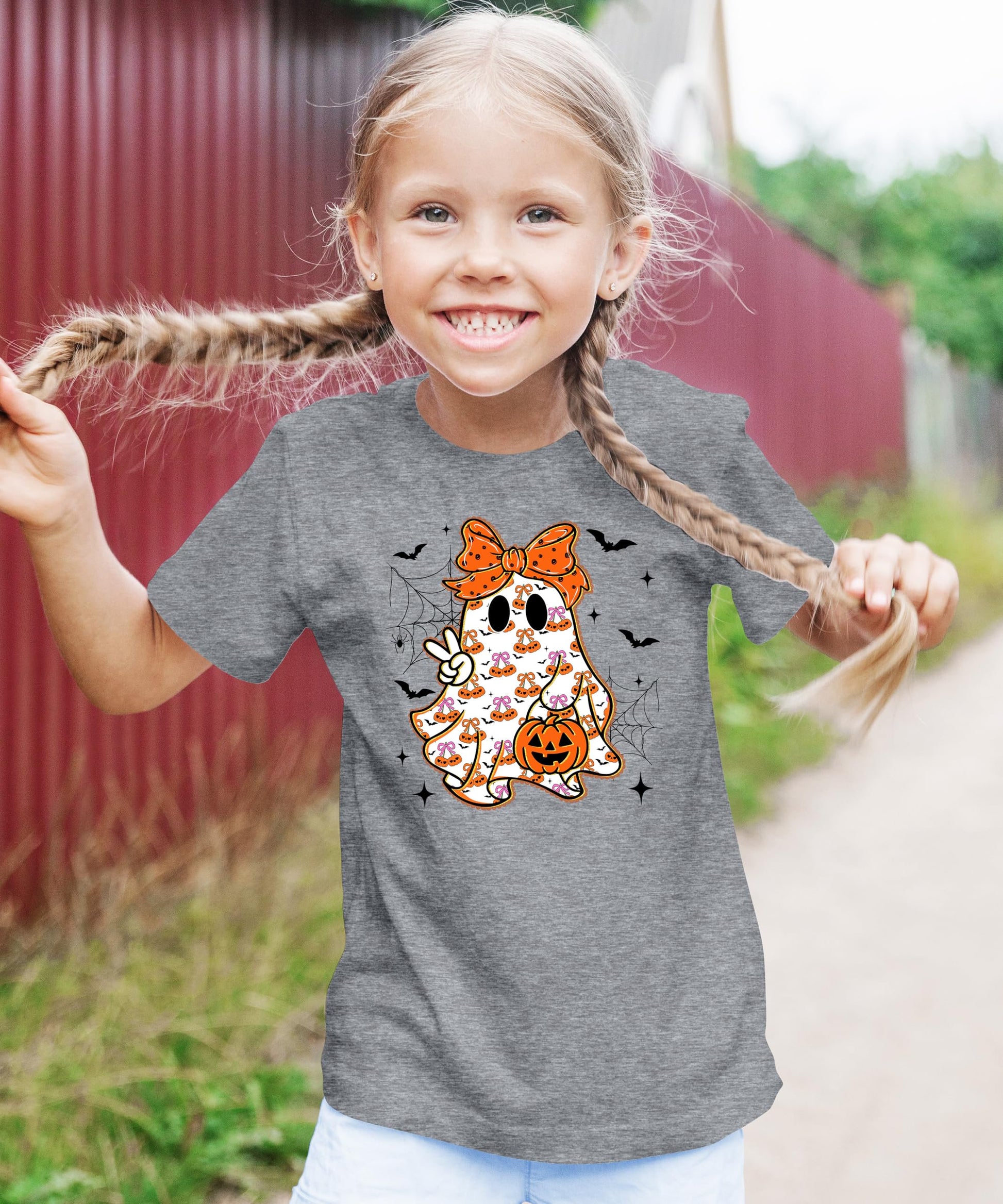 Side view of kids natural Halloween graphic tee with girly ghost and orange bow print