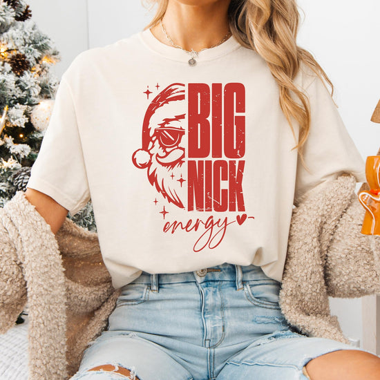 Flat lay of ivory Big Nick Energy women's holiday graphic t-shirt