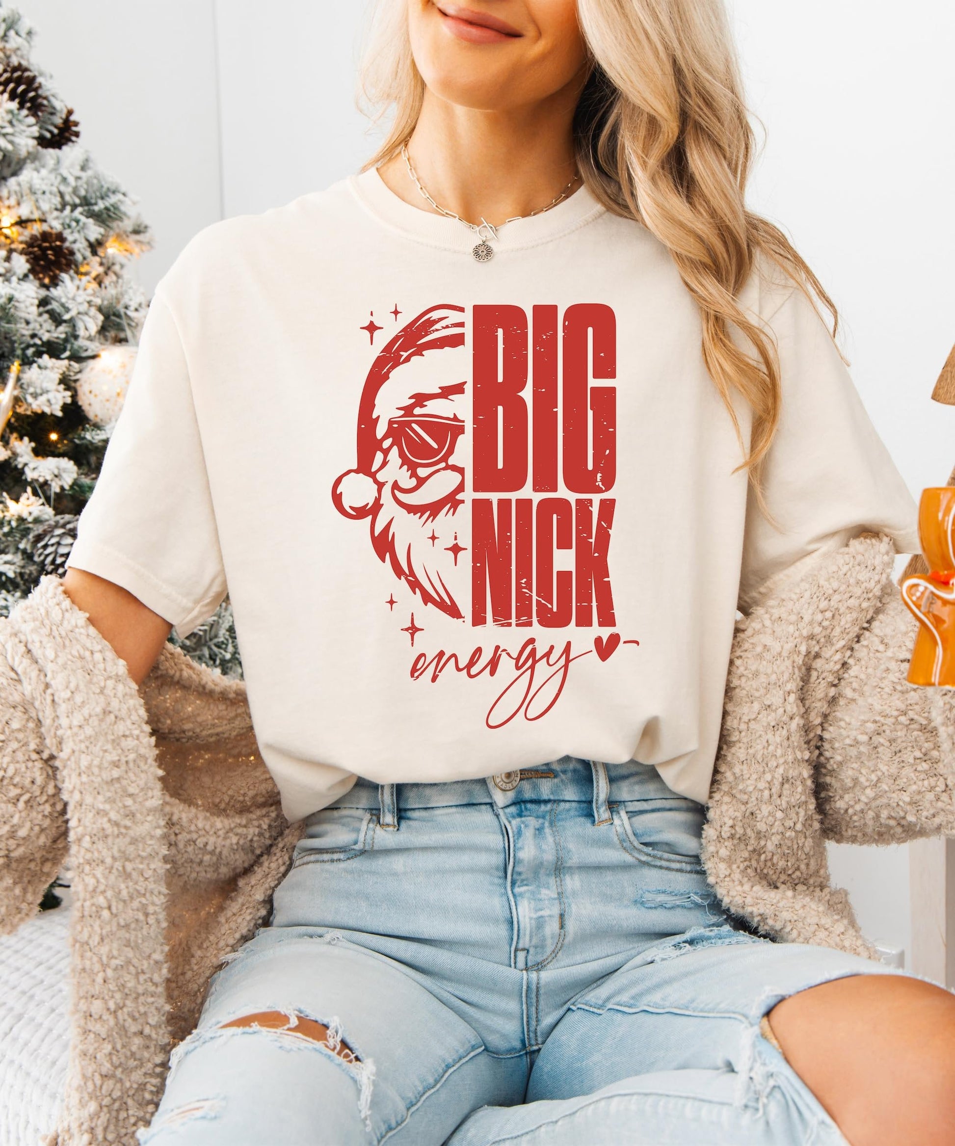 Flat lay of ivory Big Nick Energy women's holiday graphic t-shirt