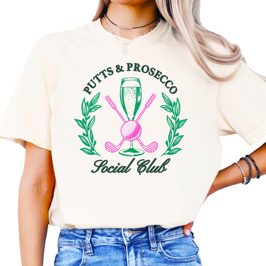 Putts and Pros Social Club ivory graphic tee for women with girly golf and wine lover design