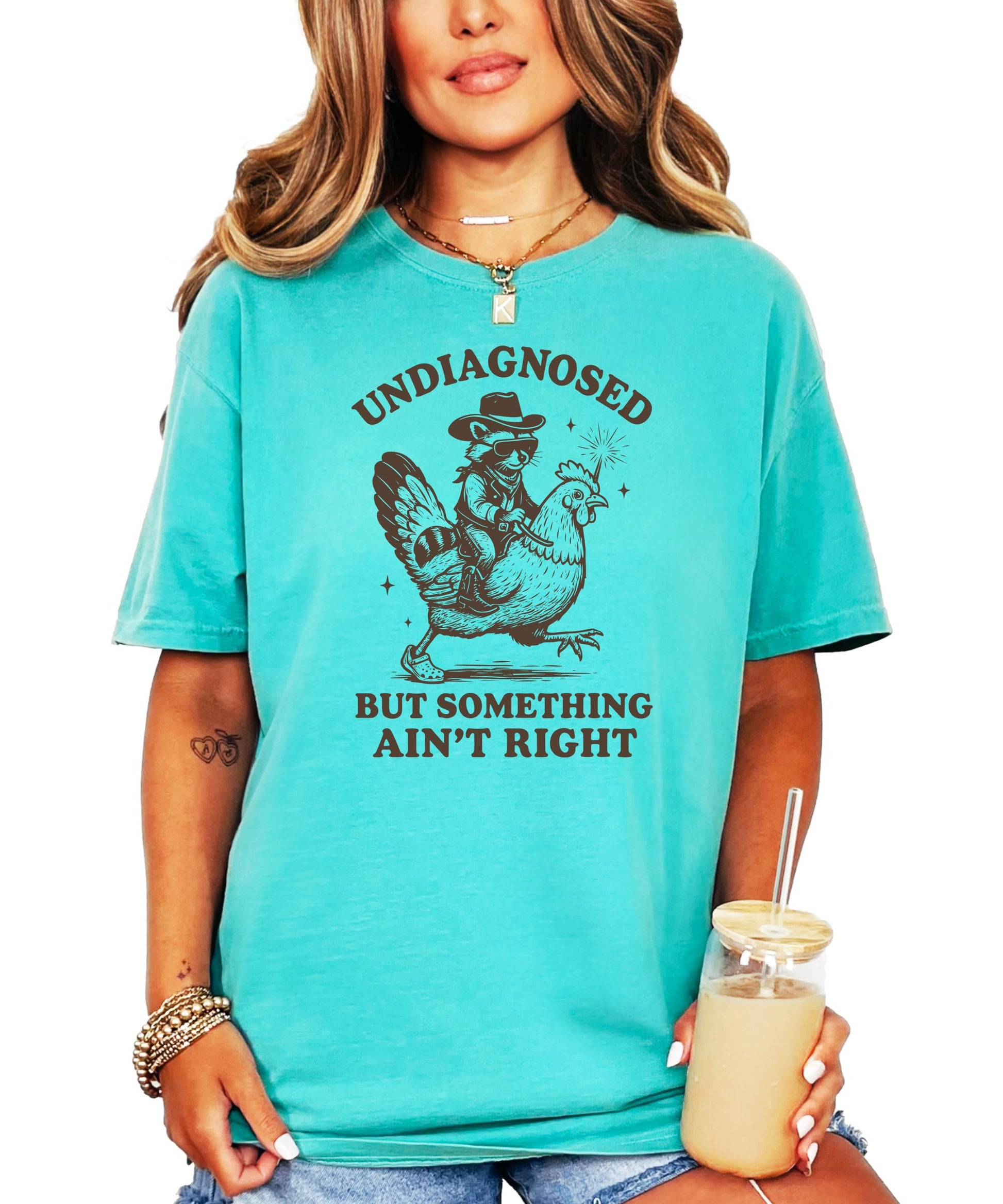 Close-up view of raccoon design with humorous text on blue jean colored shirt