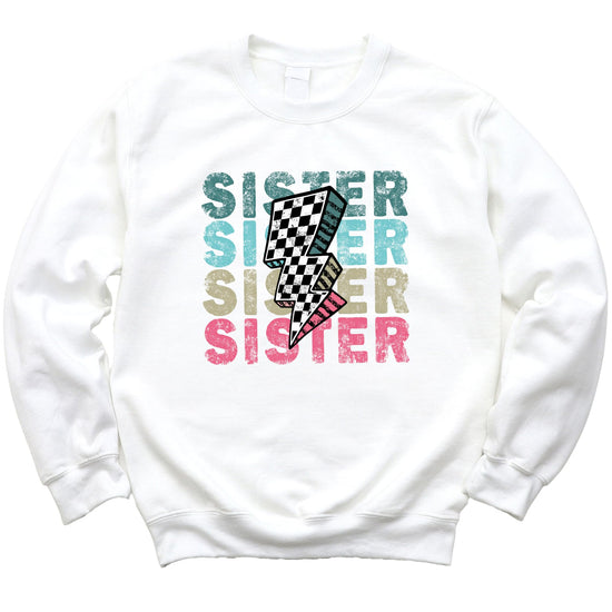 Detail shot of retro checkered lightning bolt centerpiece on girls colorful SISTER sweatshirt