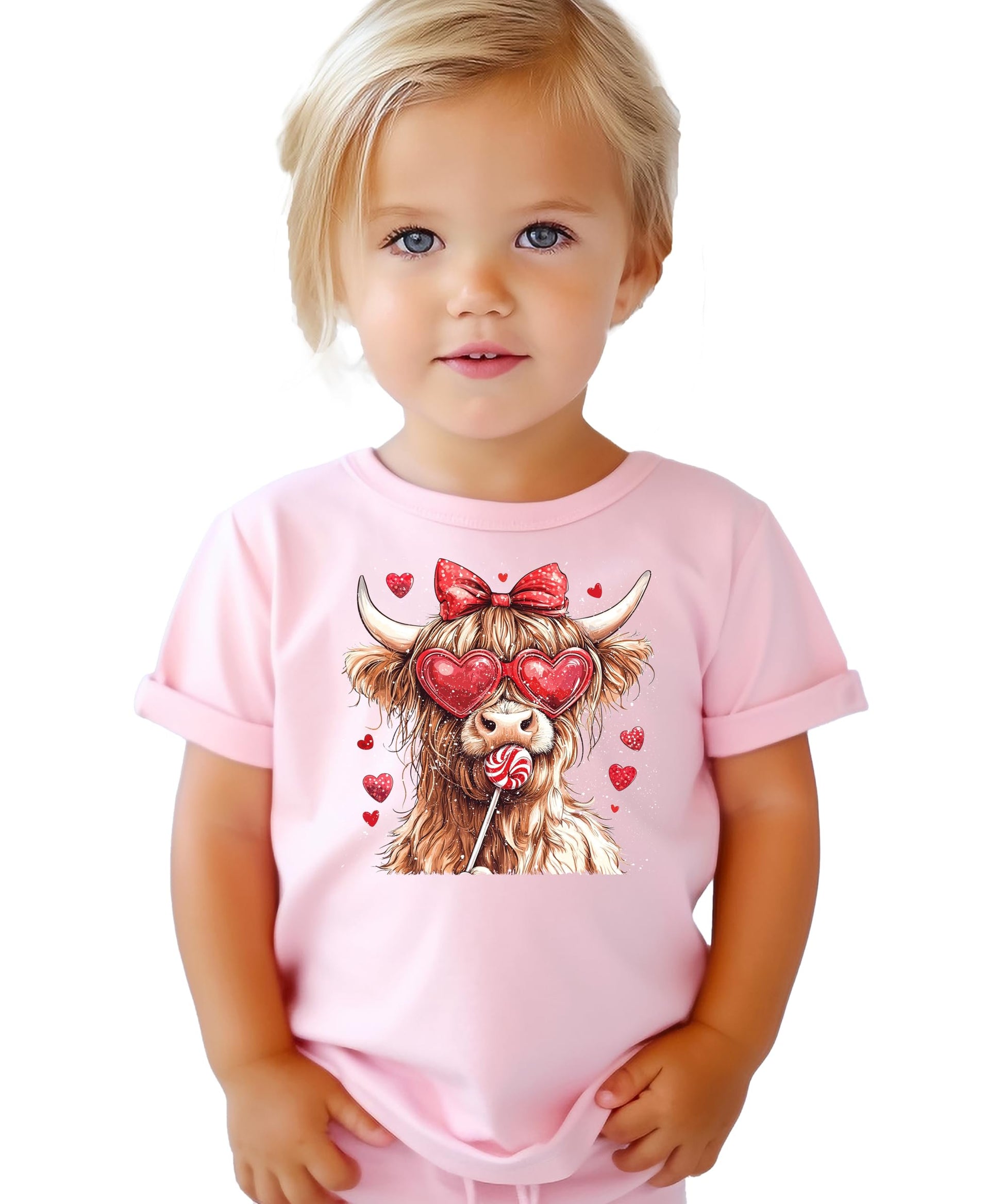 Detail shot of vibrant Highland cow and candy hearts print on girls' Valentine's tee