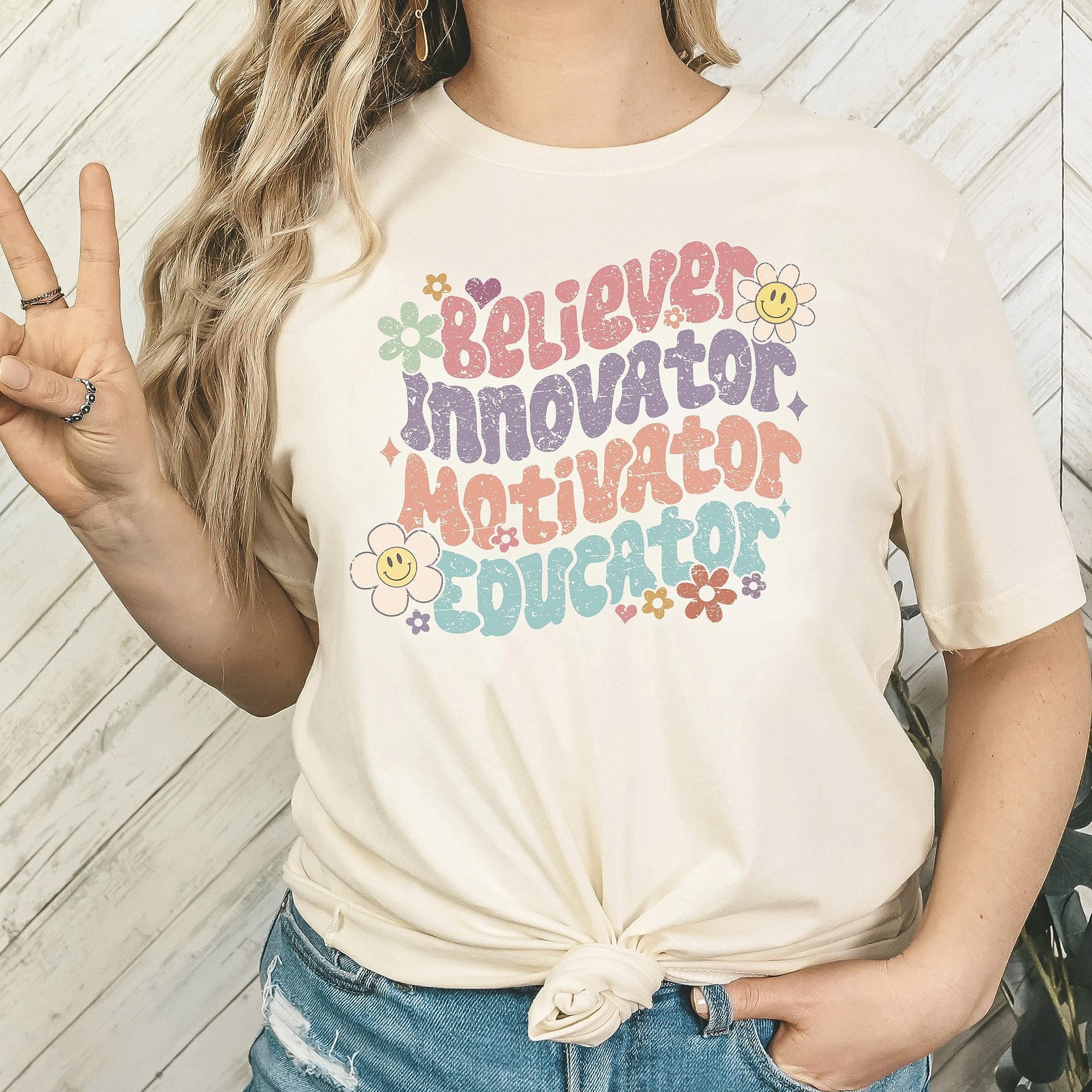 Close-up of teacher life graphic print on natural colored women's shirt