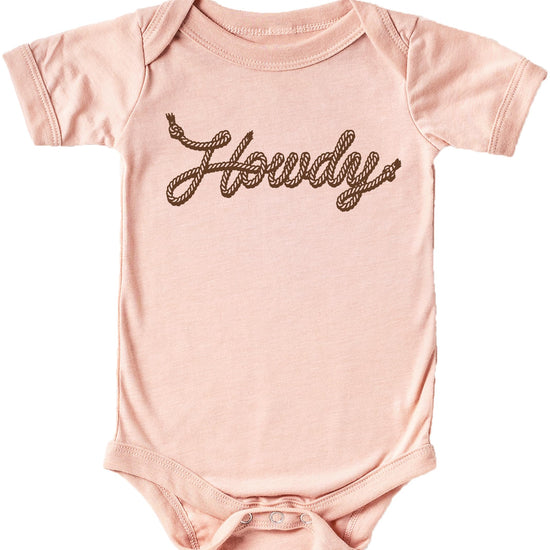 Close-up of Howdy rope script graphic on peach baby bodysuit, western-themed newborn outfit