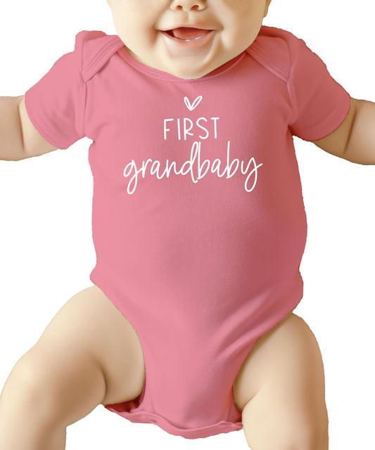 Olive Loves Apple First Grandbaby infant bodysuit folded and styled as a grandparent announcement gift