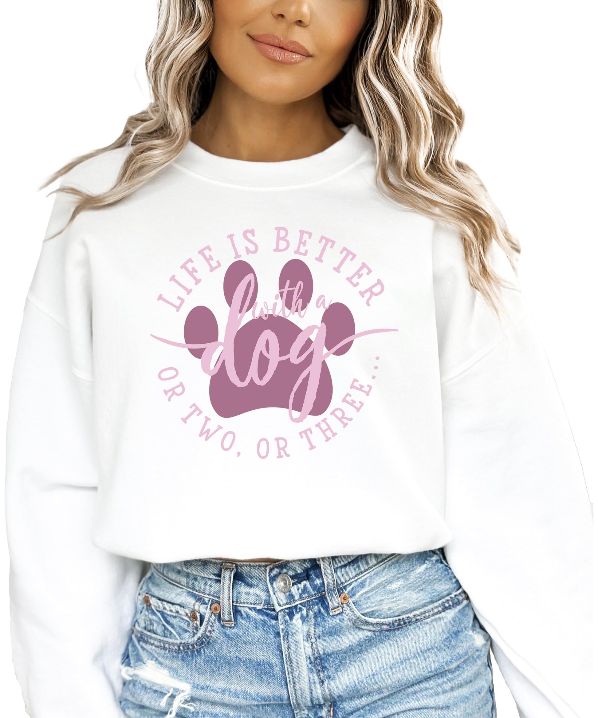 Close-up of 'Life is Better with a Dog or Two or Three' printed design on white sweatshirt